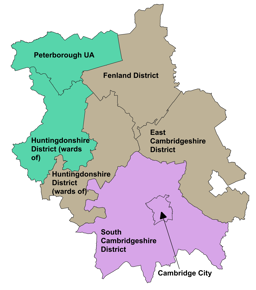 A color-coded map of Cambridgeshire and Peterborough showing districts and ward boundaries. The map includes:  Peterborough UA in teal at the top left Fenland District in brown at the top center East Cambridgeshire District in brown on the right Huntingdonshire District (wards of) in teal on the left and bottom left South Cambridgeshire District in purple at the bottom Cambridge City marked in the center with a black arrow pointing to it.