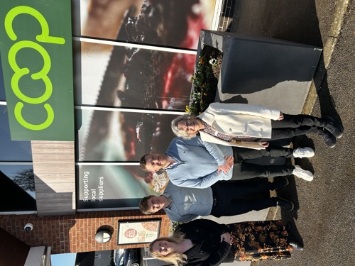 District Cllr Helene Leeming, Joel Mattless from the Co-Op, District Cllr Henry Batchelor and Cambourne Town Cllr Fran Panrucker outside the new planter at Lower Cambourne Co-Op.