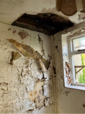 A room with a window and a broken wall

AI-generated content may be incorrect.